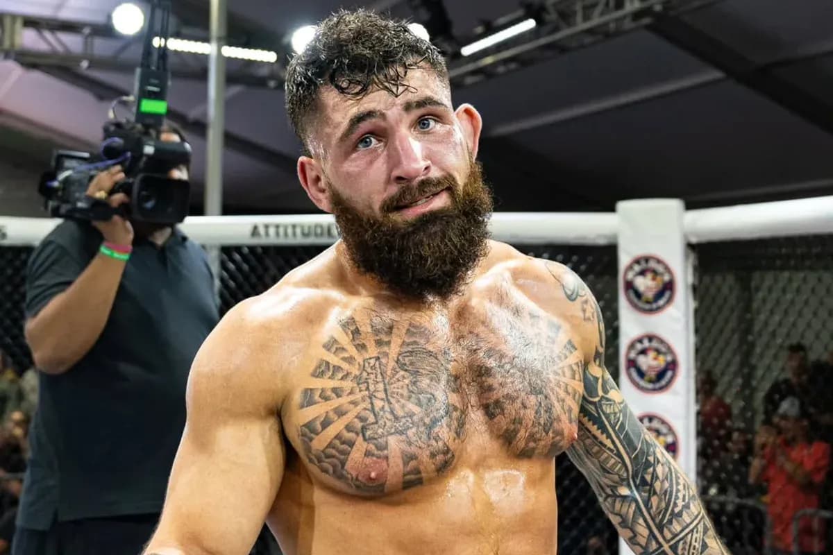 MMA fighter Chase Mann stands in the cage after a win