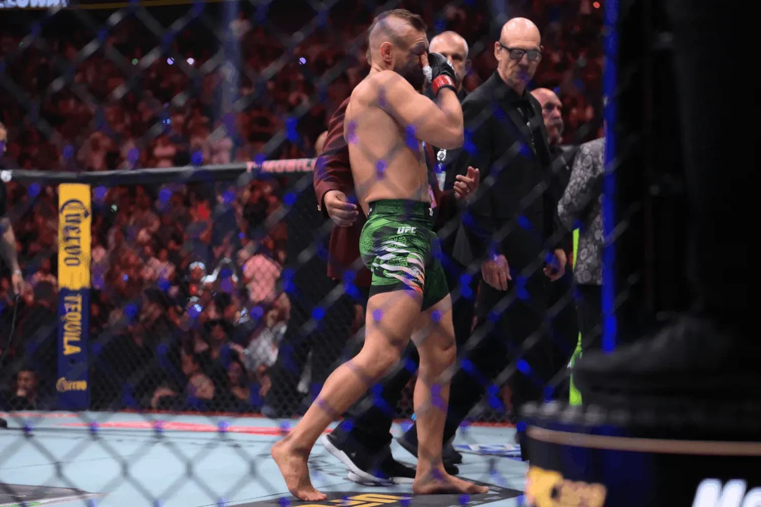 Conor McGregor walks off after his knee injury at UFC 329