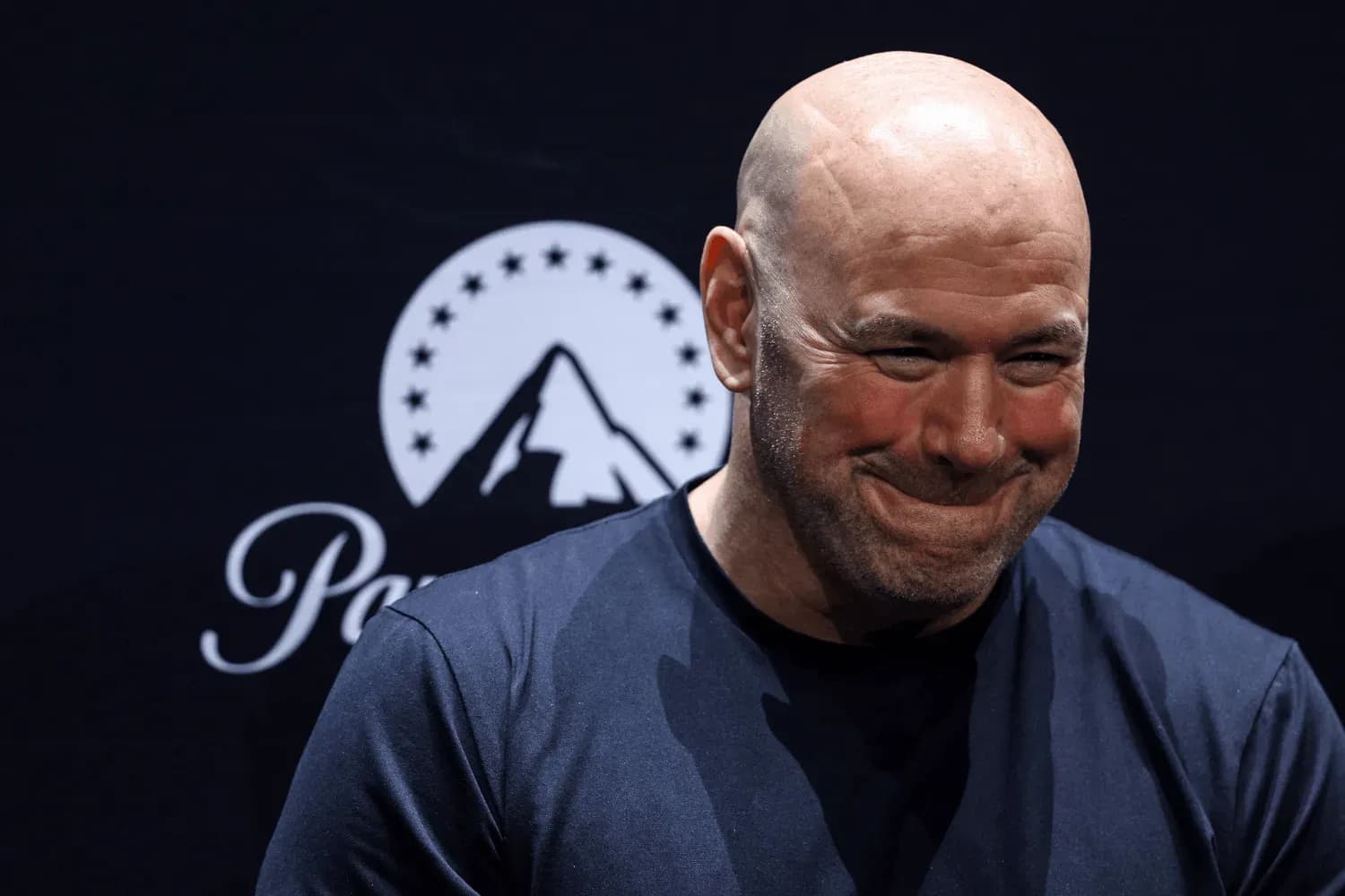 Dana White smiles on stage