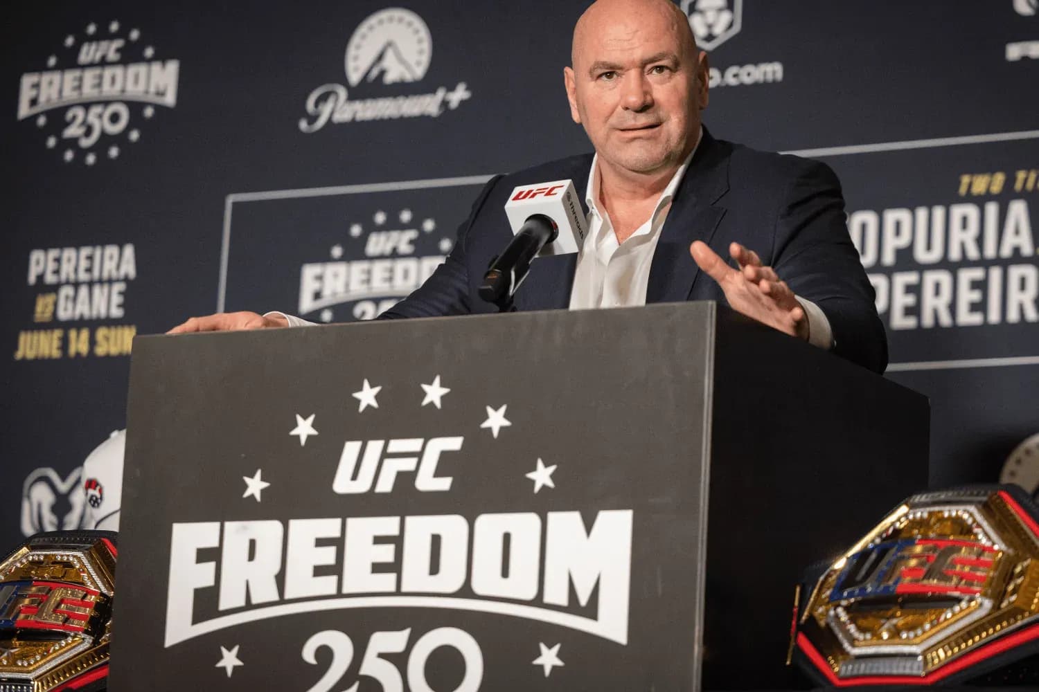Dana White stands on a podium for UFC Freedom 250