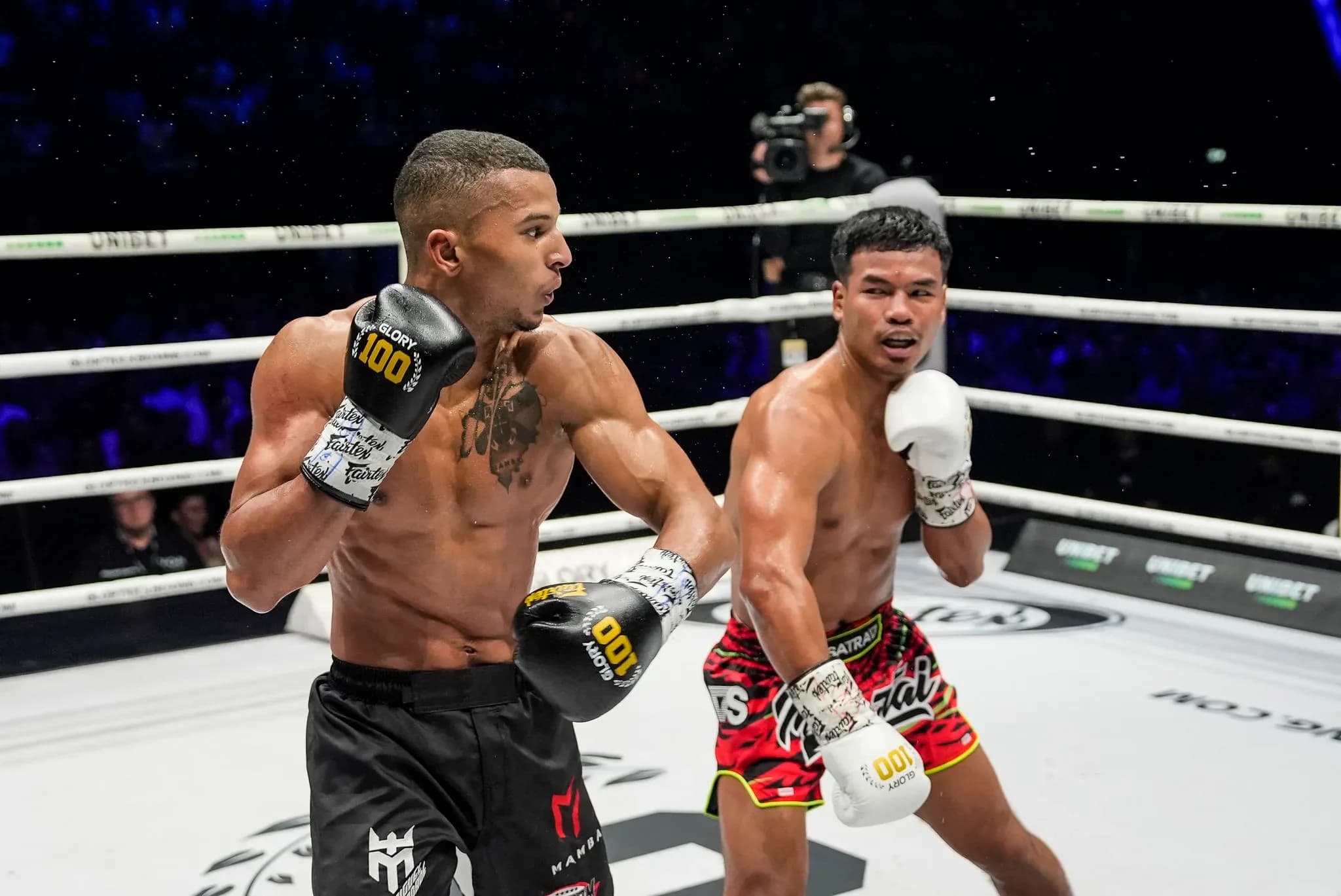 Miguel Trindade throws a left at Petpanomrung Kiatmuu9 during their featherweight title fight at Glory 100 in June 2025