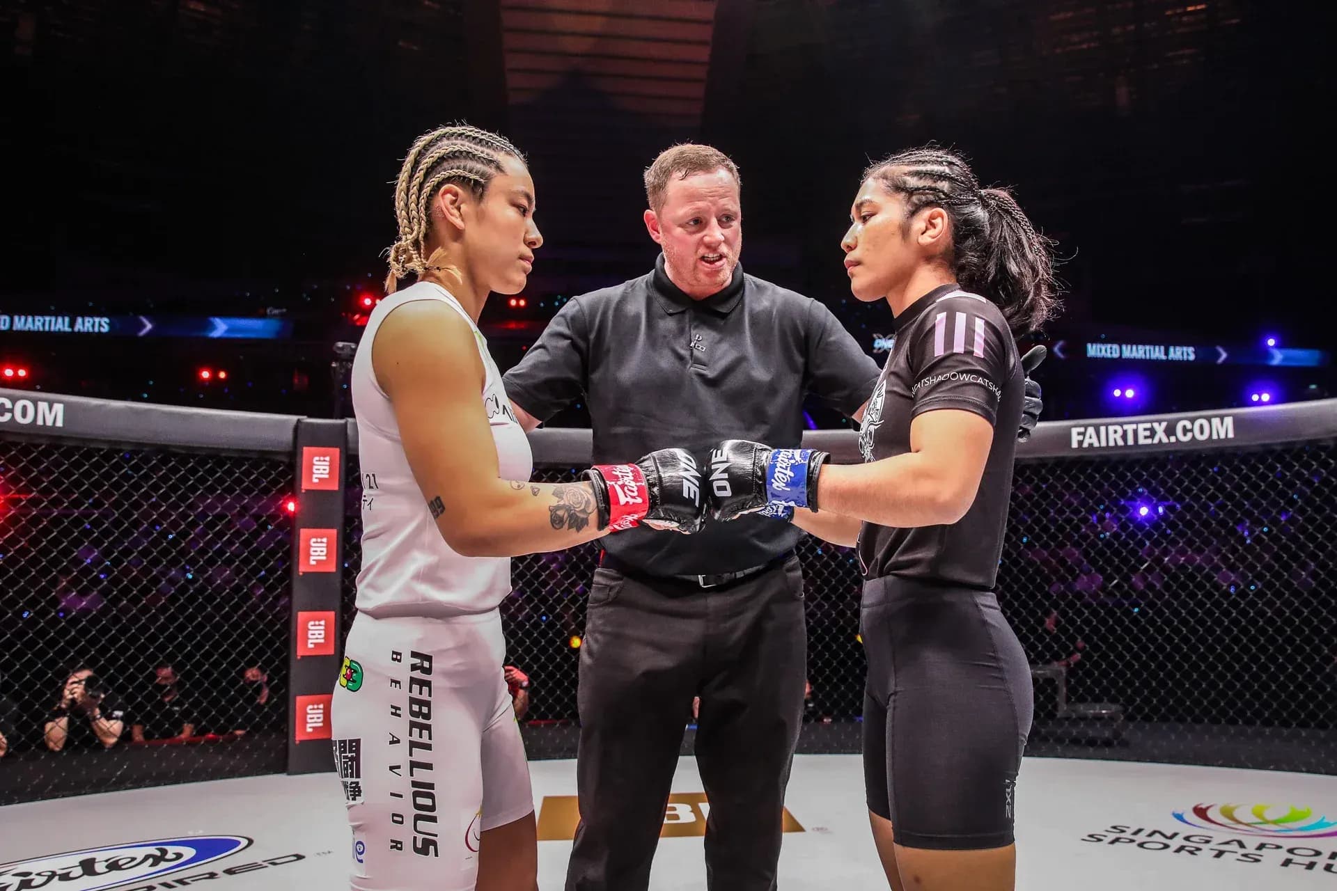 MMA fighters Itsuki Hirata and Jihin Radzuan touch gloves in the ring