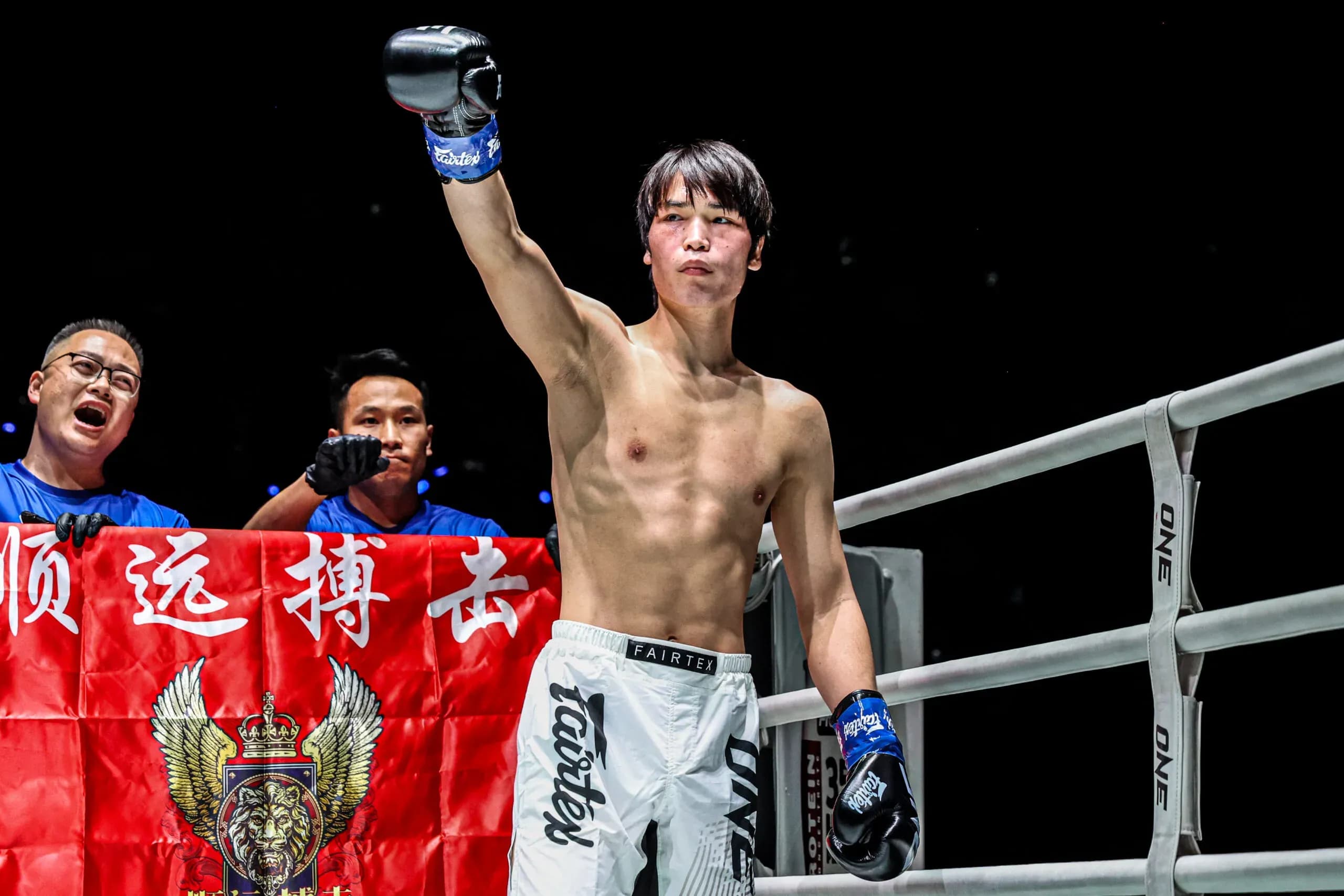 Chinese kickboxer Liu Mengyang stands in the corner with his arm raised at ONE Friday Fights 137