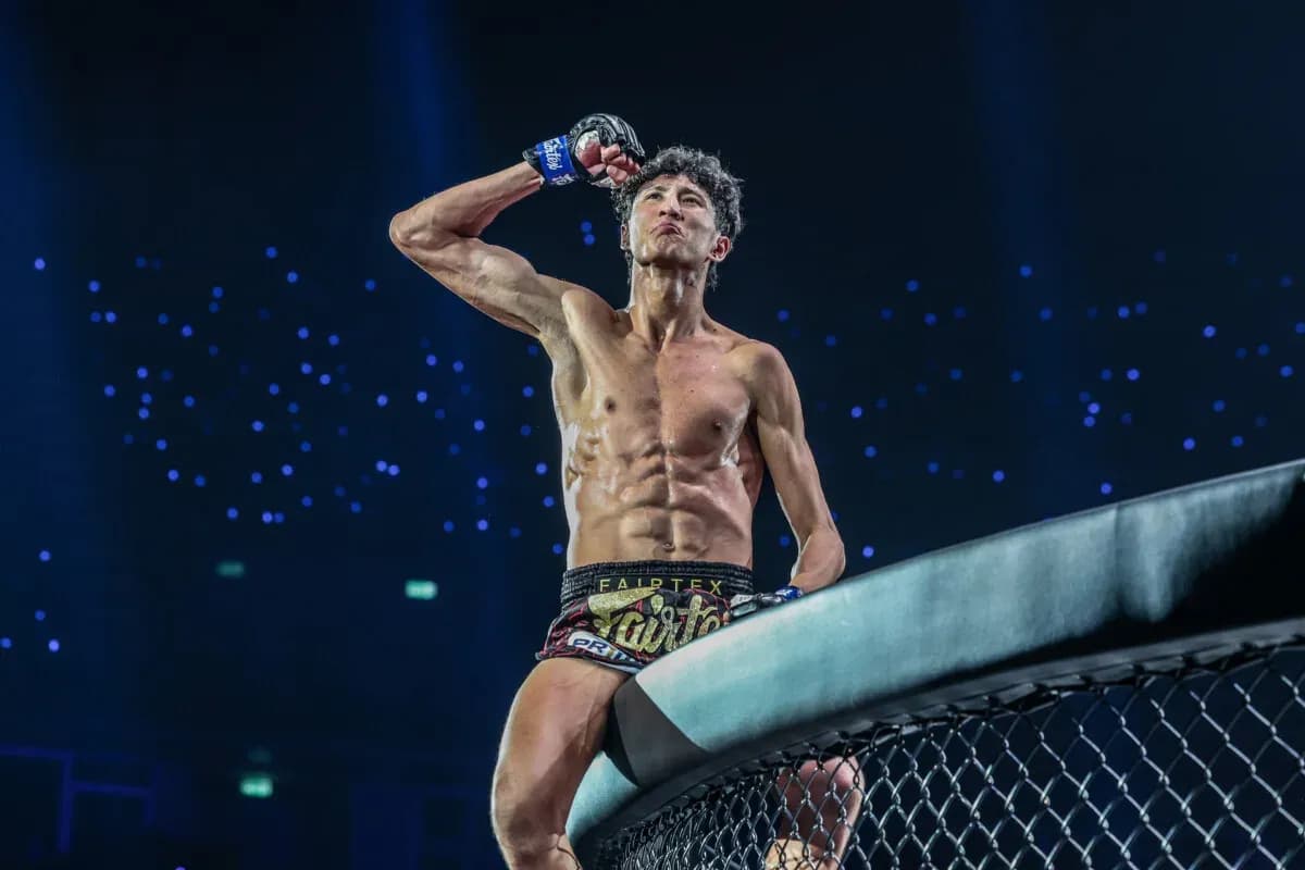 6-foot-4 Muay Thai prodigy Nabil Anane celebrates his victory on the cage