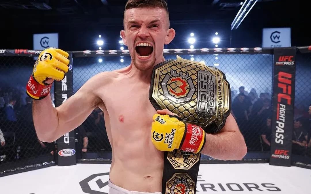 Harry Hardwick celebrates his Cage Warriors title win