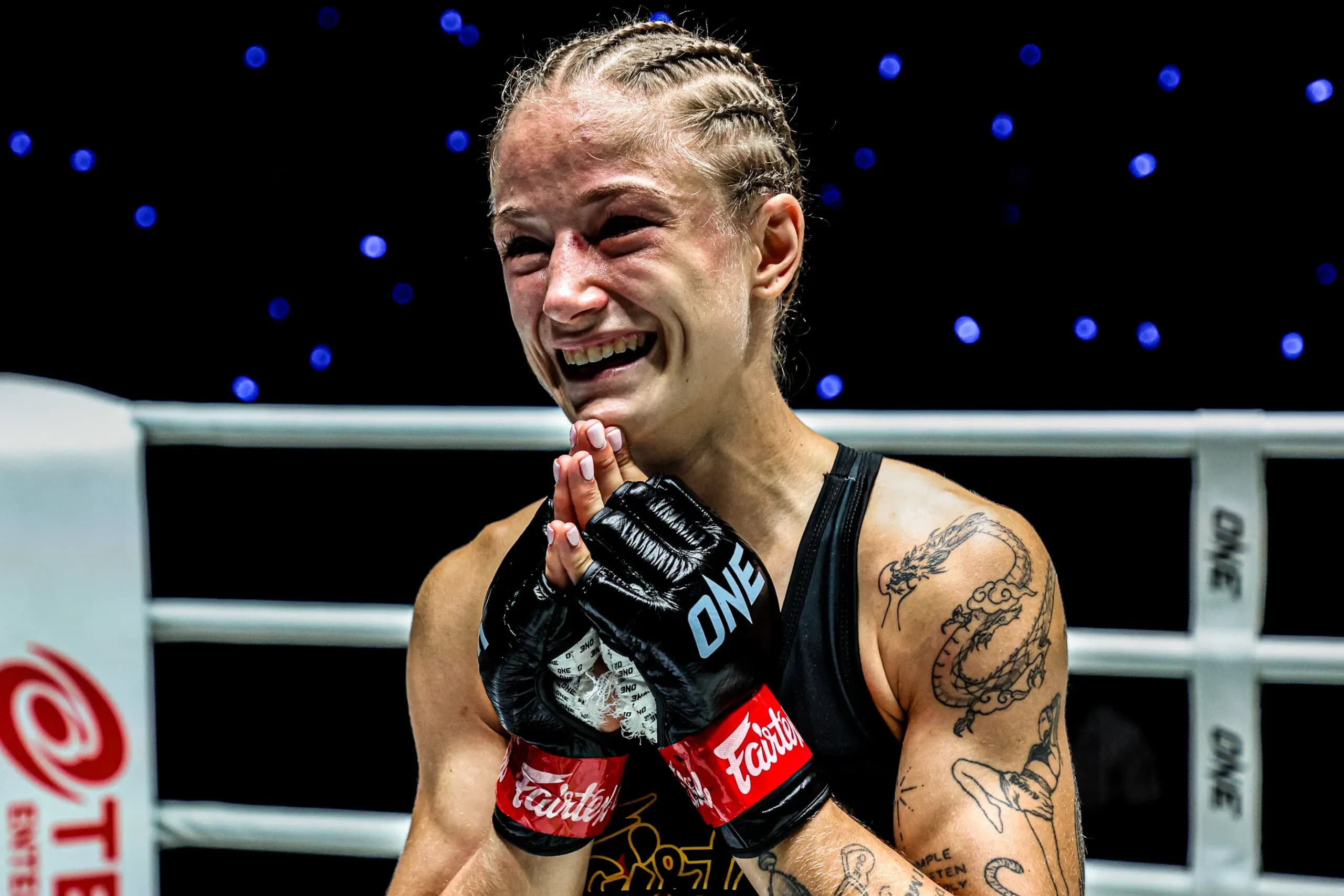 Kickboxing and Muay Thai star Stella Hemetsberger celebrates with her hands together