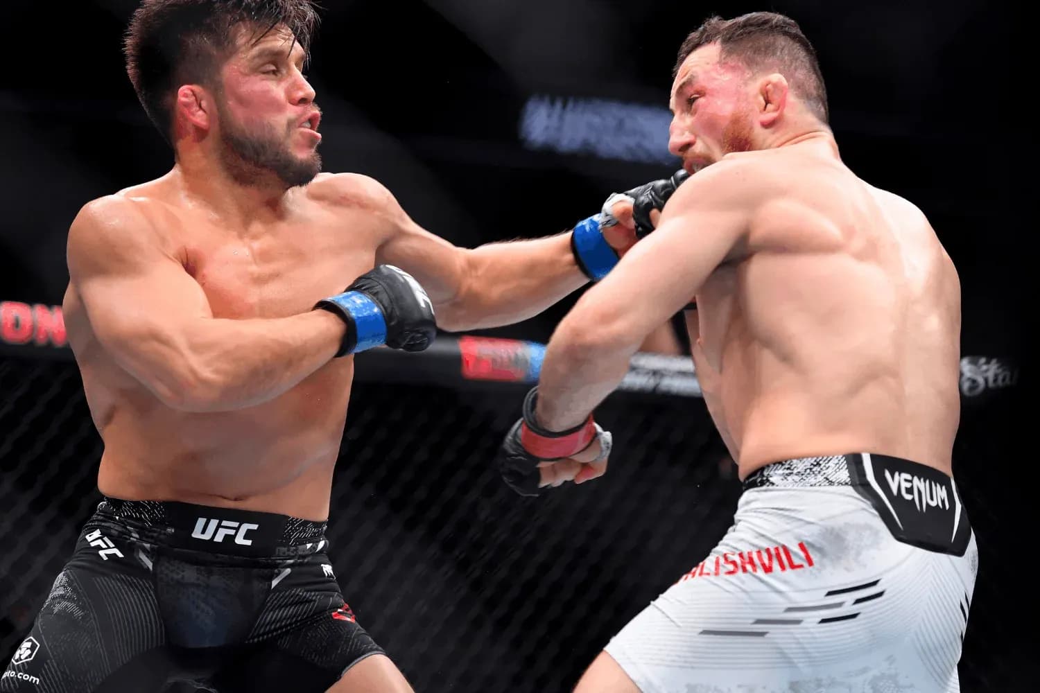 Henry Cejudo (left) lands a punch on Merab Dvalishvili (right)