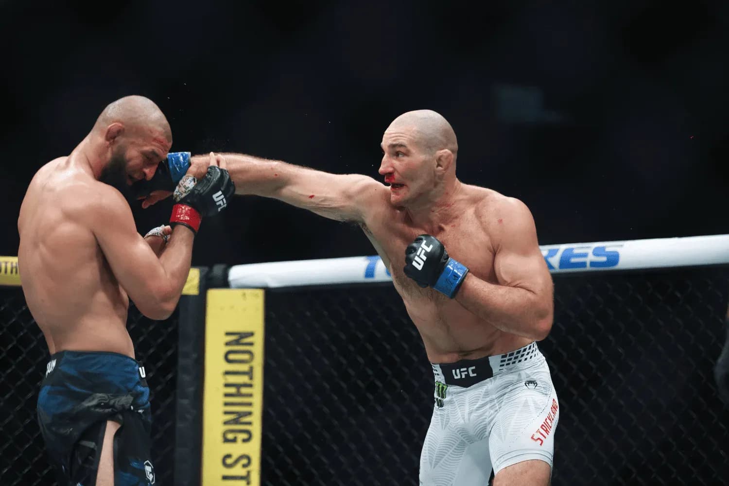Sean Strickland punches Khamzat Chimaev during his fight against in Middleweight bout at UFC 328 at Prudential Center