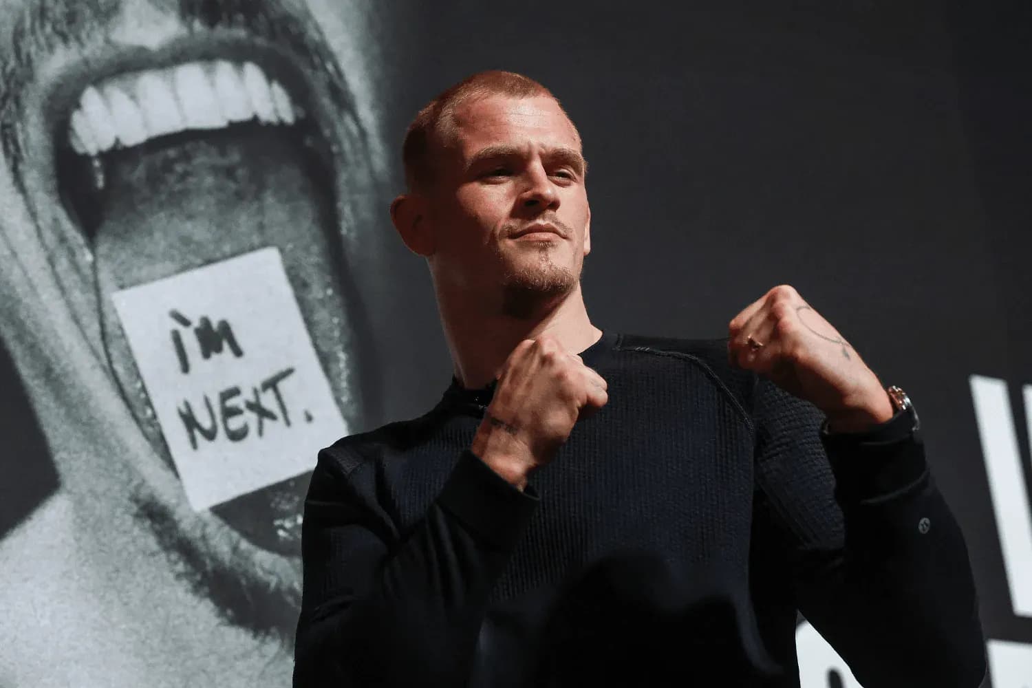 Ian Garry poses on stage