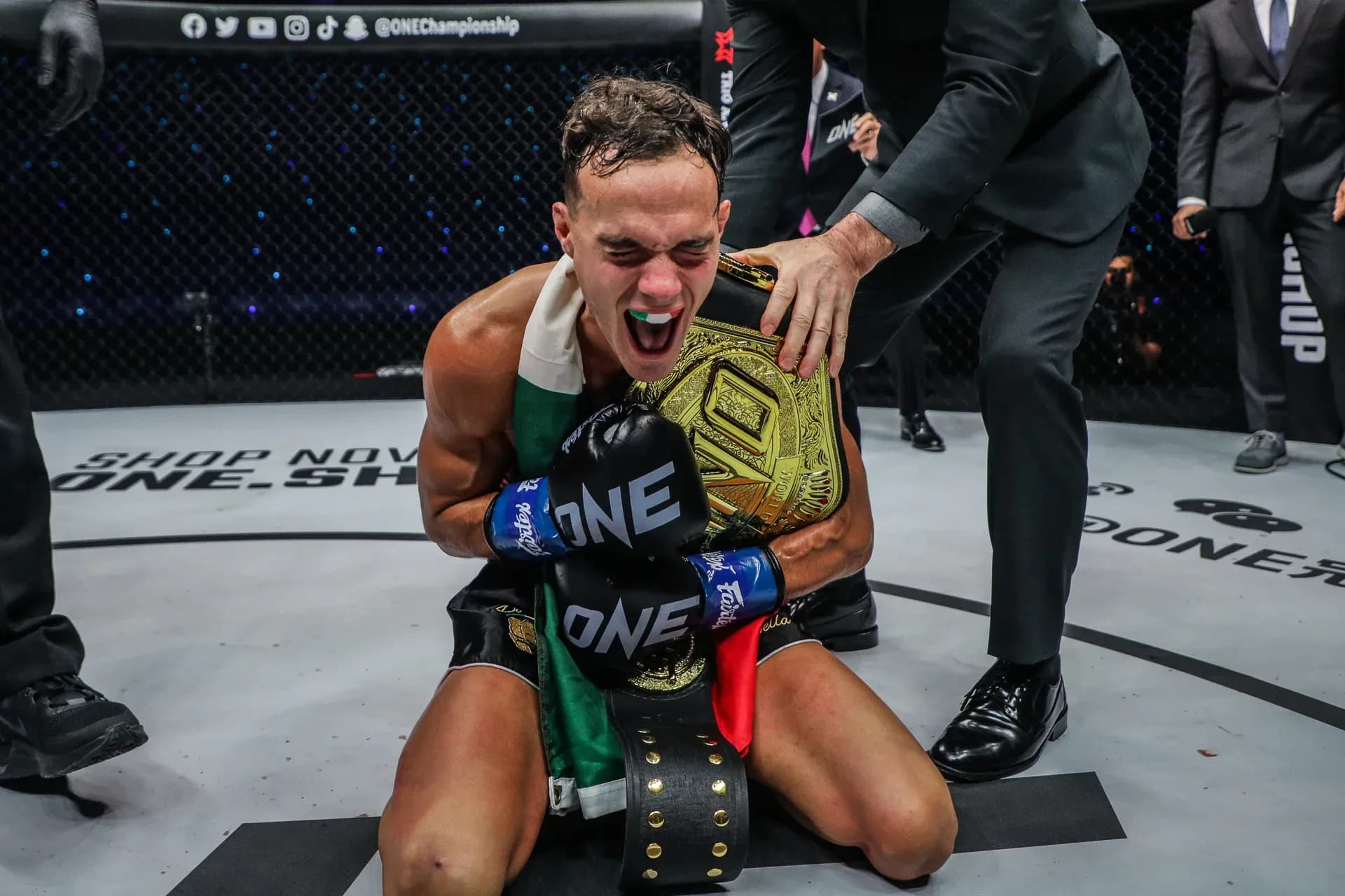 Italian-Canadian kickboxer Jonathan Di Bella celebrates with the ONE Championship belt