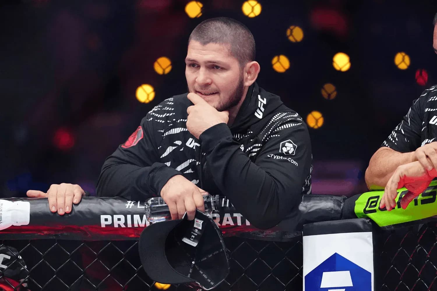Khabib Nurmagomedov stands on top of the octagon to give advice
