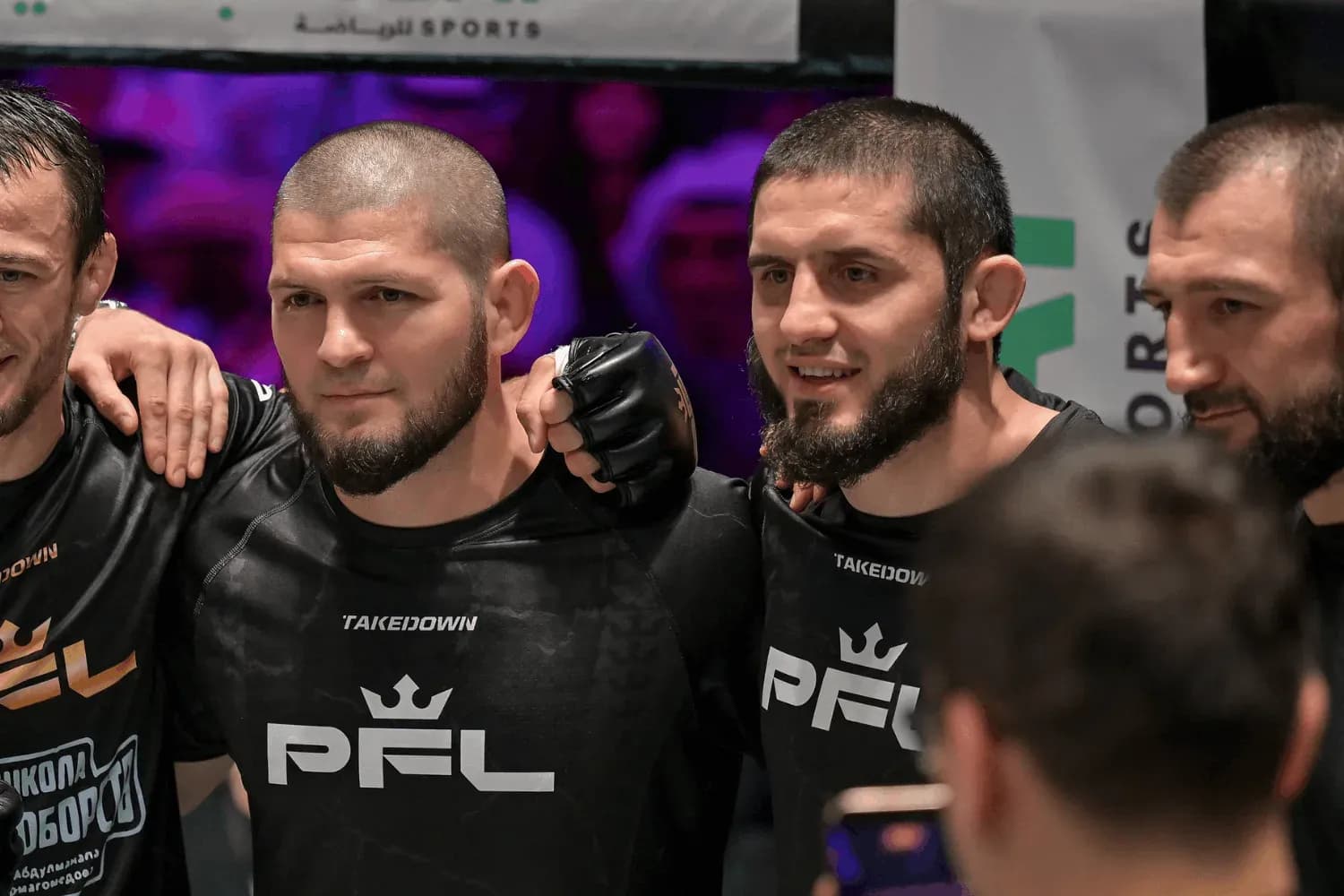 Khabib Nurmagomedov standing with Islam Makhachev