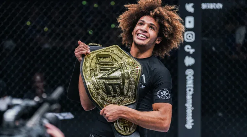 Kade Ruotolo holds the ONE Championship belt in the cage