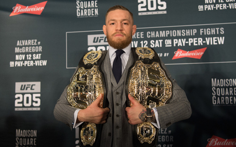Image for Conor McGregor poses with a UFC title belt