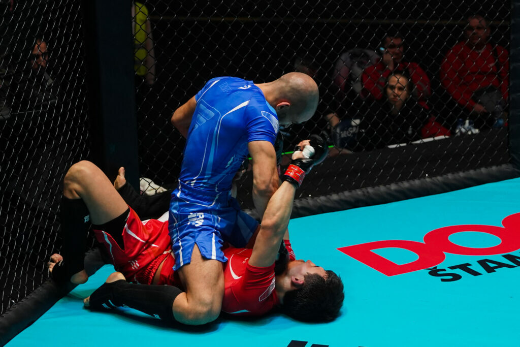 Fighter dominates his opponent with a ground and pound at the 2022 IMMAF World Championship