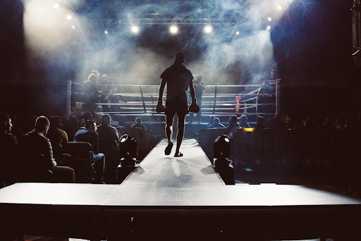 A determined boxer making his way to the ring, ready for the fight.
