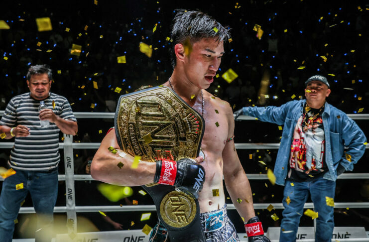 Tawanchai holds the ONE Championship belt over his shoulder