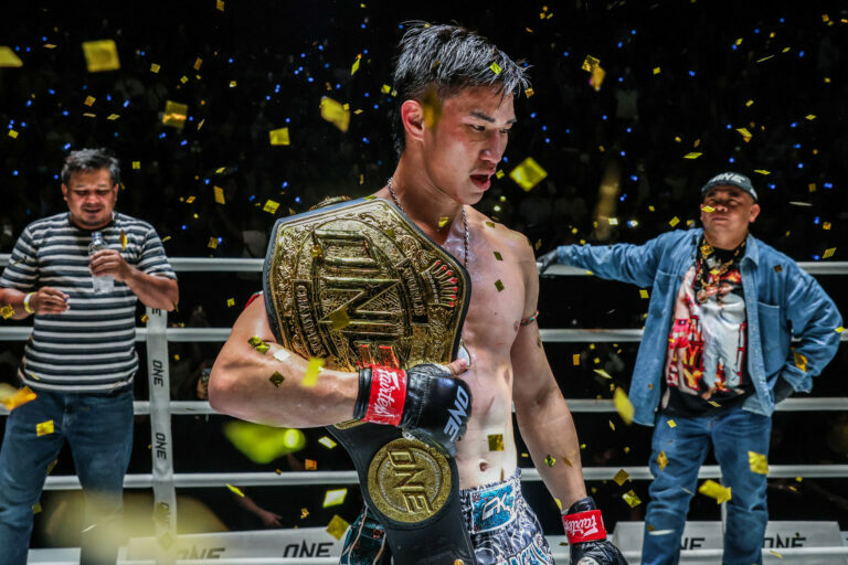 Tawanchai holds the ONE Championship belt over his shoulder