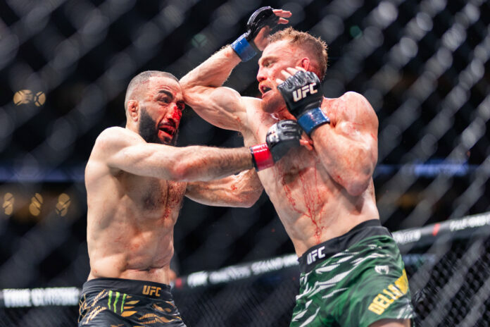 New UFC welterweight champion Maddalena lands an elbow on Belal Muhammad at UFC 315