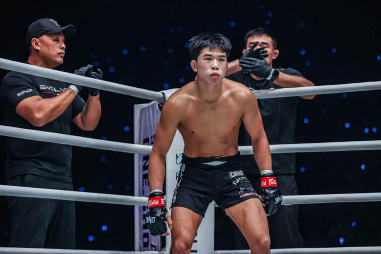 Adrian Lee stands in the ring corner