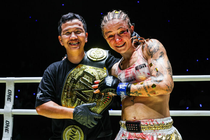 Stella Hemetsberger poses with her cornerman and the ONE Championship belt