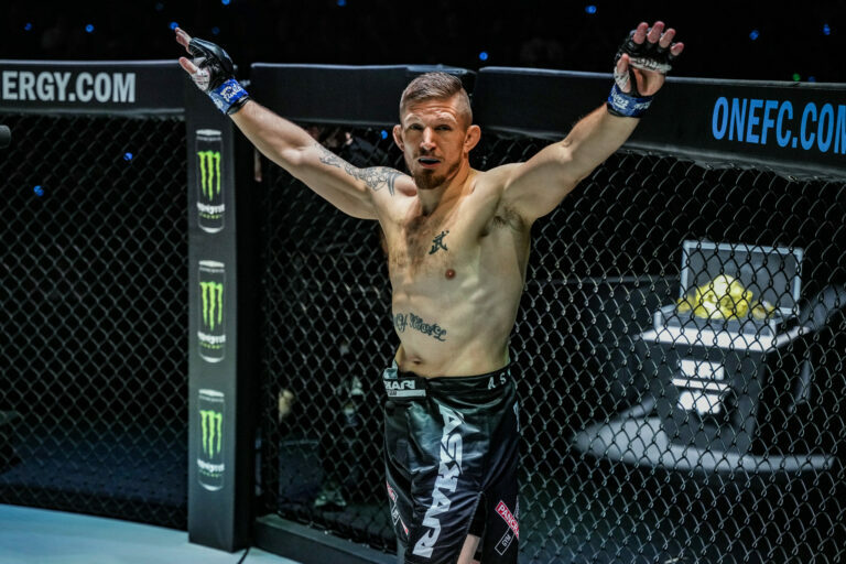 MMA fighter Zebaztian Kadestam raises his arms