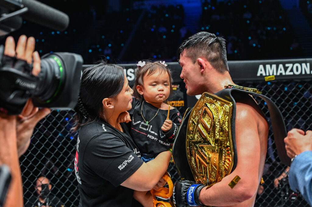 MMA star Christian Lee with the belt and his family