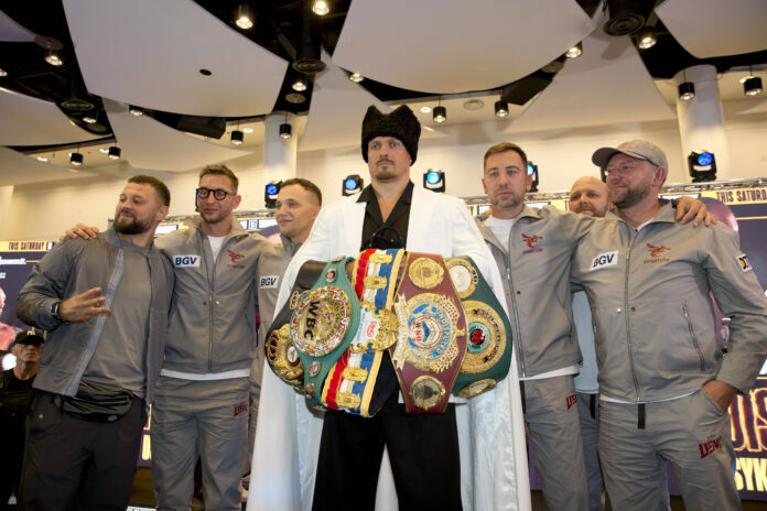 Oleksandr Usyk holding belts