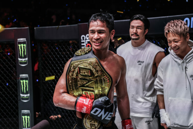 Superbon celebrates his win in the Circle with the ONE Championship belt