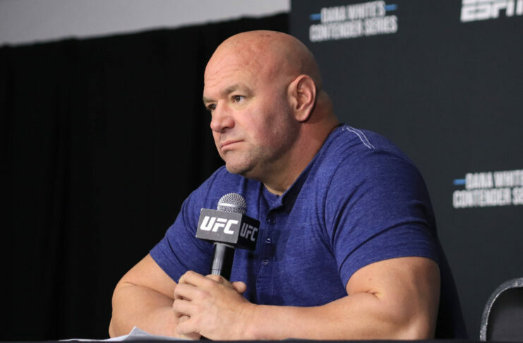 Dana White holding a microphone at UFC Apex venue - sports wagering in MMA