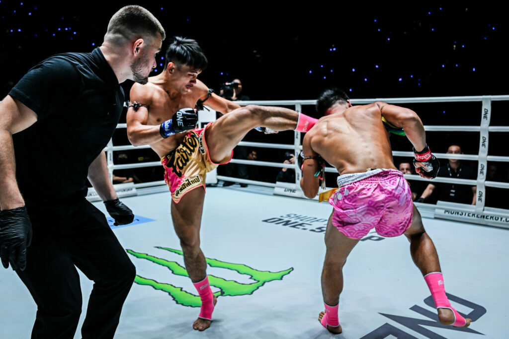 Muay Thai fighter Jaosuayai Mor Krungthepthonburi lands a head kick in the ring