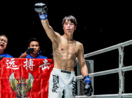 Chinese kickboxer Liu Mengyang stands in the corner with his arm raised at ONE Friday Fights 137